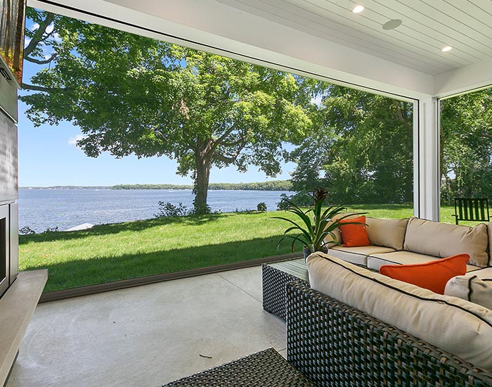 Lakeside luxury home with large covered patio and beautiful yard