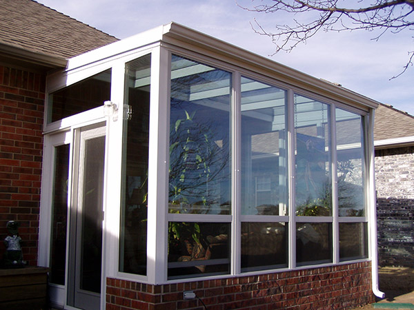 Glass finished entrance in brick design house